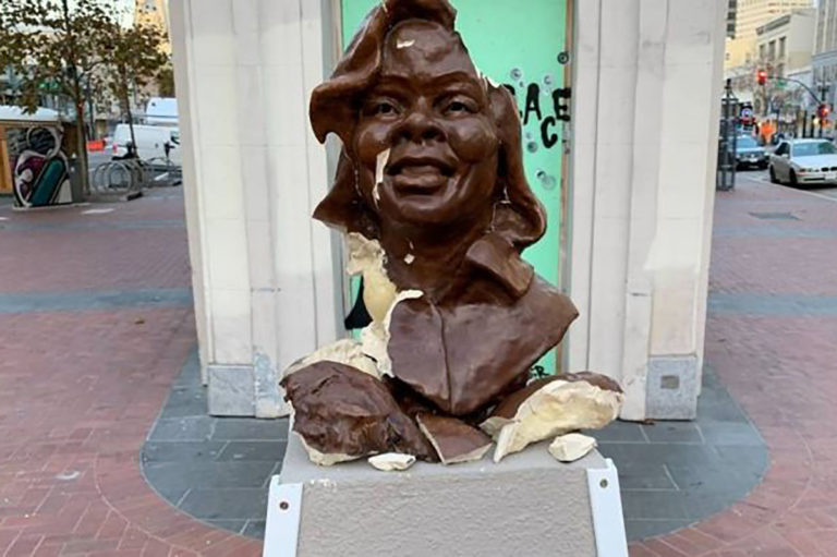 White hero smashes statue of fat black woman