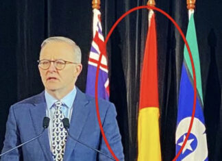 Idiot AnAl hangs aboriginal flag upside down