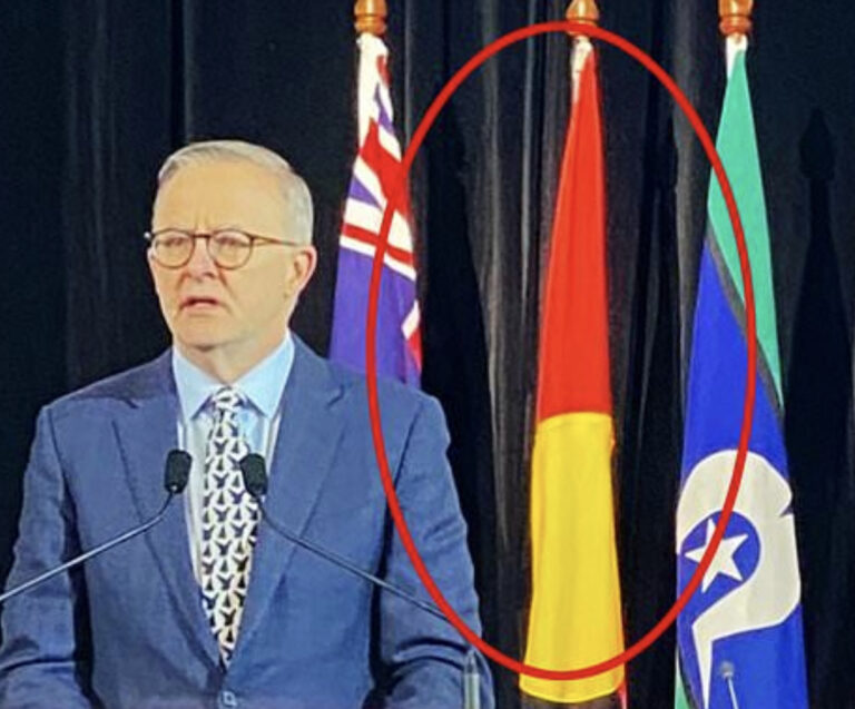 Idiot AnAl hangs aboriginal flag upside down